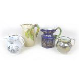 A group of four water jugs, including a Clarice Cliff tall jug with leaf and branch stylised handle,