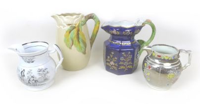 A group of four water jugs, including a Clarice Cliff tall jug with leaf and branch stylised handle,