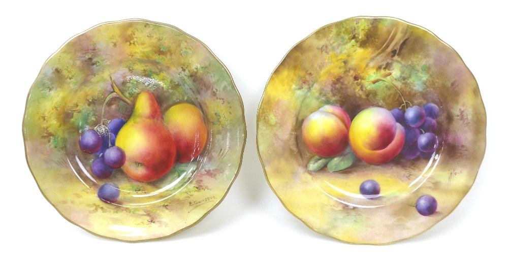A pair of Royal Worcester plates, painted with fruit to a mossy ground, dated 1926, puce factory