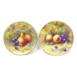 A pair of Royal Worcester plates, painted with fruit to a mossy ground, dated 1926, puce factory