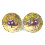 Two Royal Worcester cabinet plates, hand painted by Horace Price, each with a fruit study to mossy