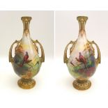 A pair of Royal Worcester twin handled vases, painted with pheasants in pine trees in an all round