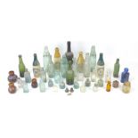 An assortment of vintage glass and stoneware bottles, including Trealaw Rhonda Valley Aerated