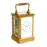 A French 19th century repeating brass carriage clock, retailed by Dent, London, with white enamel