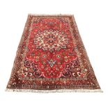 A Bakhtiari rug, with a caucasian central medallion, on red ground with profuse floral decoration,