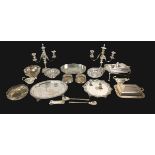 A collection of silver plated wares, including a pair of candelabra, a lidded serving dish on stand,