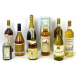 A group of vintage wine and spirits, including a bottle of 1964 Chateau Carbonnieux, Leognan. (9)