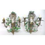 A pair of Rococo style gilt metal, two branch wall lights, modelled with Dresden porcelain