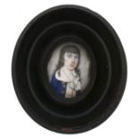 A portrait miniature on ivory depicting a boy in a blue coat with long black hair, possibly 17th