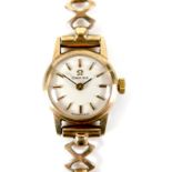 An Omega 9ct gold lady's wristwatch, circa 1965, model 511.5182, with circular champagne dial,