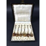 A set of six silver gilt and enamel coffee spoons, in case, marked '925 S. G. G.', total weight 1.48