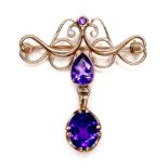 An Edwardian 9ct gold amethyst and diamond brooch, largest amethyst 9mm by 7mm, a pear shaped cut