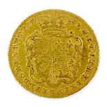 A George II gold guinea, 1732, obverse with George II young head above EIC, reverse with quartered
