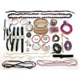 A group of costume jewellery, including a string of pink hard stone beads, amethyst bead