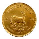 A 22ct gold South African Krugerrand, 1974, 'Fyngoud 1oz Fine Gold', 32.4mm, 34.0g.