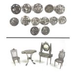 A collection of thirteen silver buttons, together with a group of four white metal doll house