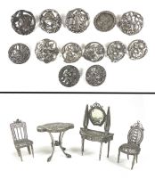 A collection of thirteen silver buttons, together with a group of four white metal doll house