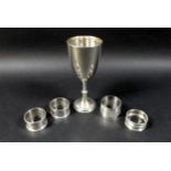 A group of silver items, comprising a Victorian silver goblet, rubbed marks, London 1887, and four