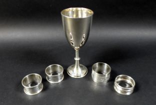 A group of silver items, comprising a Victorian silver goblet, rubbed marks, London 1887, and four