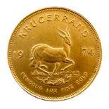 A 22ct gold South African Krugerrand, 1974, 'Fyngoud 1oz Fine Gold', 32.4mm, 34.0g.