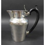 An Edwardian silver hot water jug, with ebonised handle, hinged lid, Charles Boyton (III), London
