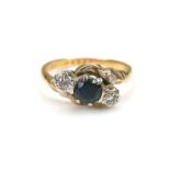 An 18ct gold and platinum mounted sapphire and diamond ring, the central round cut sapphire, 4.7mm