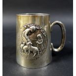 A silver christening mug with embossed mother, child, and sheep to front, I S Greenberg & Co.