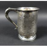 A George VI silver tankard, engraved with initials, possibly 'J.W.M', scroll handle raised upon a