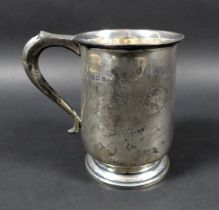 A George VI silver tankard, engraved with initials, possibly 'J.W.M', scroll handle raised upon a