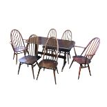 An Ercol dining table, 136 by 68.5 by 74cm high, and six chairs, including two carvers, all in a