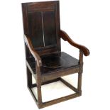 A 17th century oak Wainscot chair, with open scroll end arms, solid seat with octagonal section