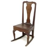 An 18th century oak rocking chair, with shaped top rail, urn form back slat, solid seat, raised upon