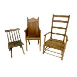 Three 19th century oak chairs, comprising a a pine armchair with solid back and armrests, 53 by 55