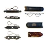A collection of five 18th and 19th century folding spectacles, four tortoiseshell, and one white