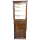 A Victorian oak corner cupboard, three open shelves painted white, single door below, 38 by 72 by