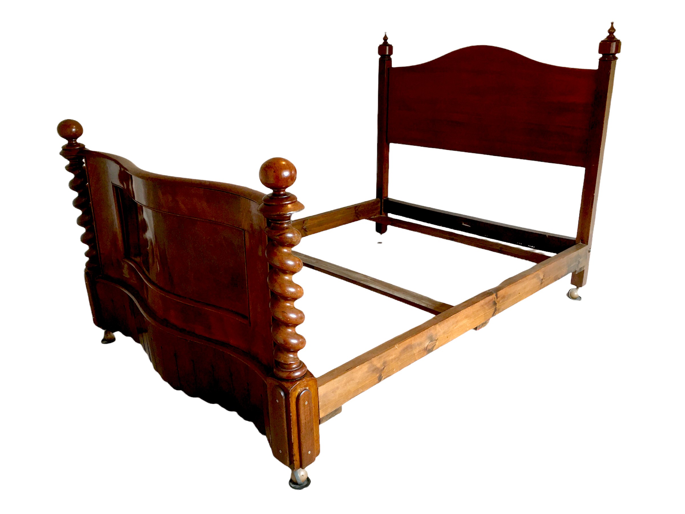 A Victorian mahogany double bed frame, serpentine foot board, and decorative spiral twist columns.