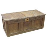 A 17th century oak chest, the front carved with two large lunettes above four small lunettes, lock