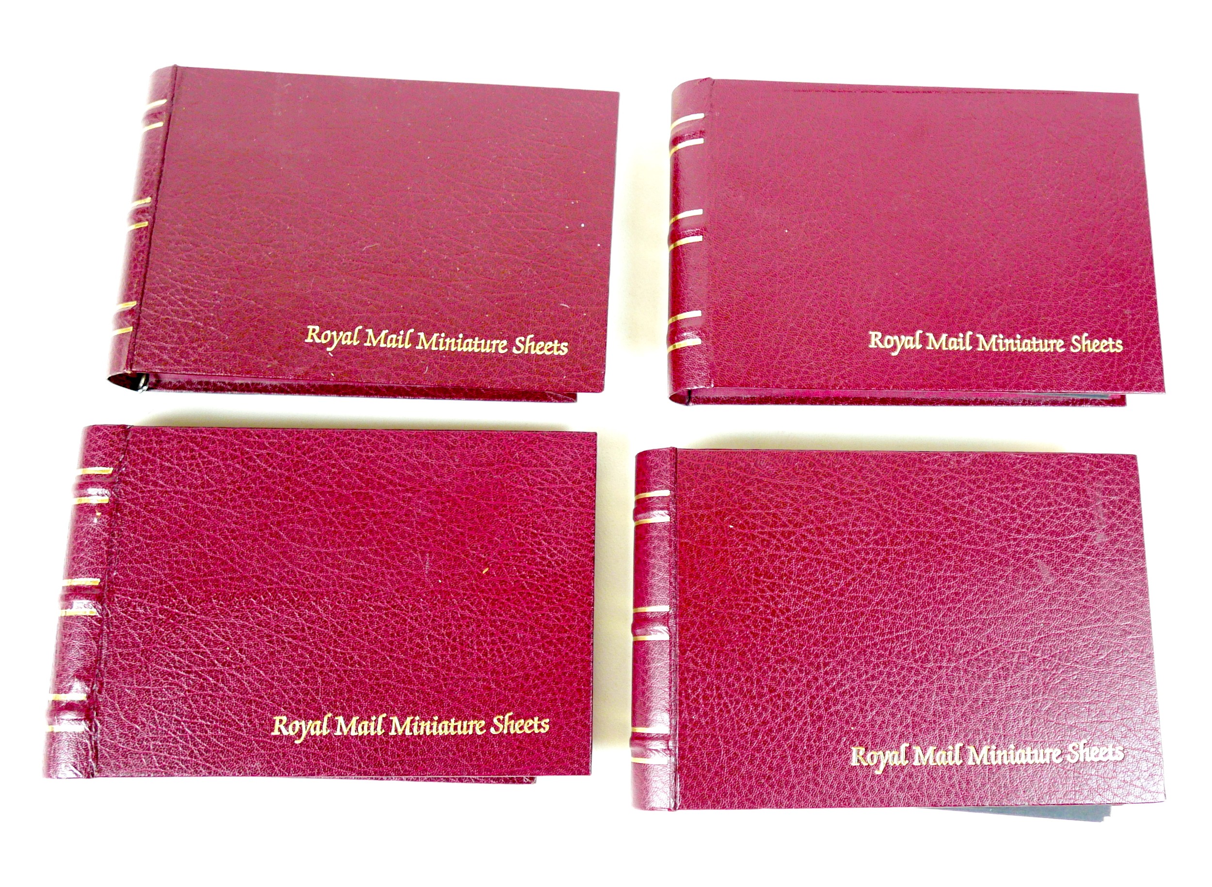 A collection of Royal Mail miniature stamp sheets, in four burgundy albums. (4)