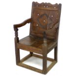 A late 17th century oak Wainscot chair, with open shaped arms, later solid seat, single (split)