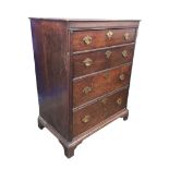 A Georgian oak chest of four drawers, with brass plate handles and escutcheons, raised upon