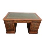 An early 20th century mahogany pedestal desk, with single central drawer flanked by two banks of