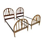 A pair of Edwardian single beds, with mahogany bed ends and VONO cast iron stretchers, each bed 92