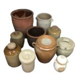 Ten various stoneware storage jars and planters, including a large terracotta planter. (10)