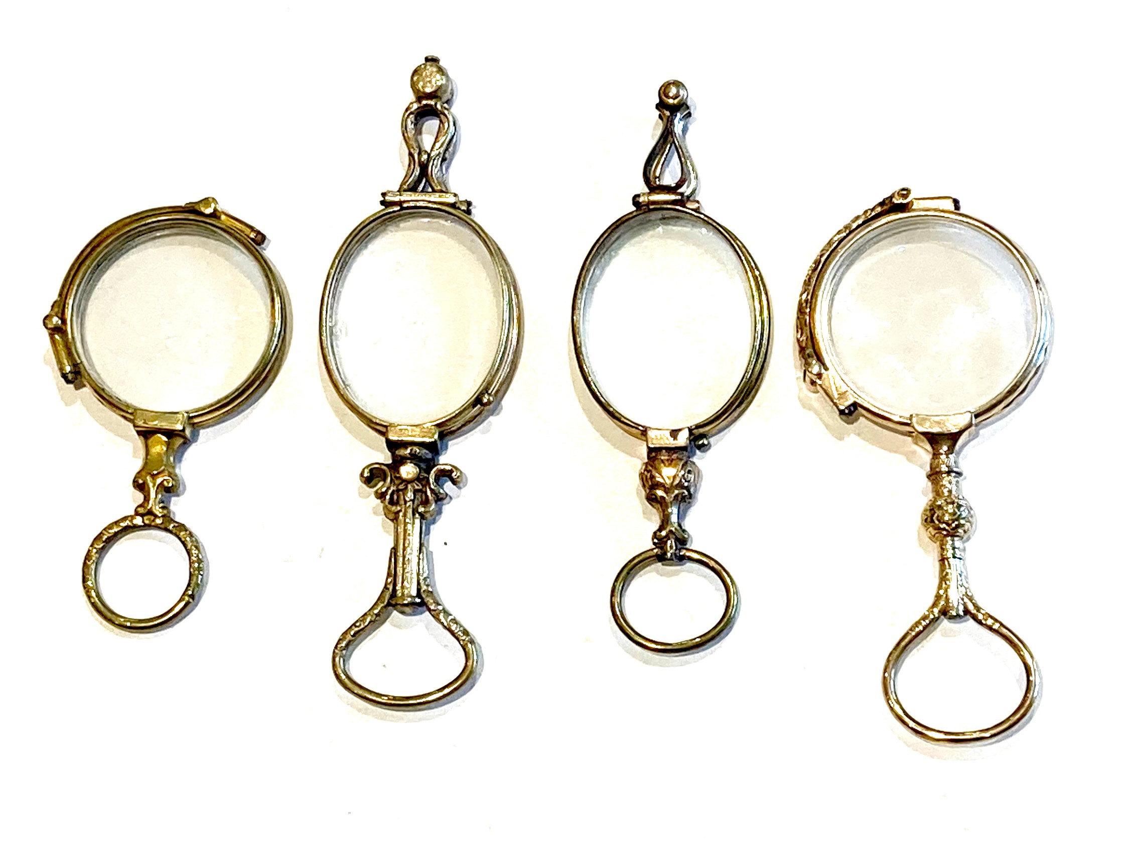 A group of four 18th and 19th century folding lorgnettes, two with oval lenses and two with circular