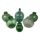Six early 20th century and later glass carboys, the largest a green carboy, 49cm high. (6)
