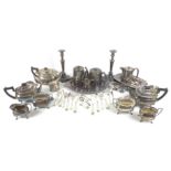 A large collection of silver plated items, including tea sets, flatware, a pair of candlesticks,