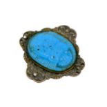 An Egyptian turquoise scarab beetle, mounted upon a white metal mount inlaid with four marcasite