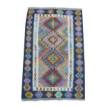 A Chobi Kilim rug, colourful central panel with four geometric lozenges, surrounded by deep blue