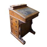 A Victorian walnut Davenport, with marquetry inlaid top, a leather inset to its writing slope, a/