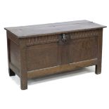 An 18th century two panelled oak coffer, with lift lid, carved frieze, raised on straight legs,